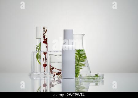 Concept of laboratory tests with types of glassware and a white bottle arranged on the table. Seaweed increasing hydration and transepidermal water lo Stock Photo