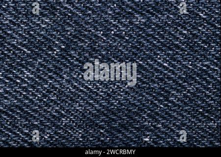 Denim surface, blue jeans fabric, front side, from above. Sturdy cotton warp-faced fabric. Type of textile. Stock Photo