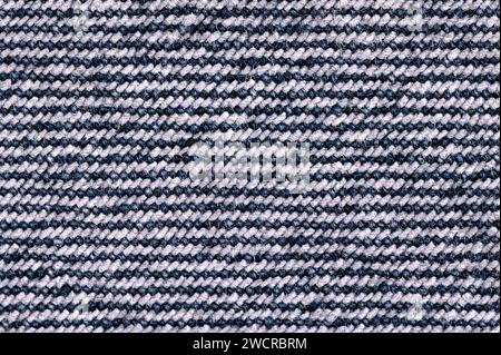 Backside of denim surface, blue jeans fabric, from above. Sturdy cotton warp-faced fabric. Type of textile. Stock Photo
