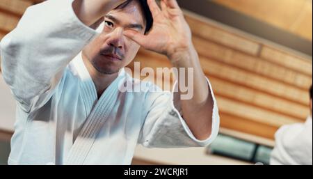 Learning, karate or Asian man in dojo for kung fu for fitness, discipline or self defense for focus or honor. Training, workout or martial arts Stock Photo