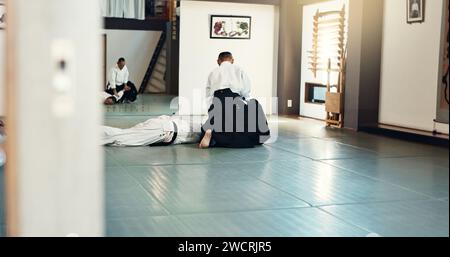 Students, karate or man teaching martial arts in dojo for fitness, discipline or self defense for combat Demonstration, workout or kung fu master Stock Photo