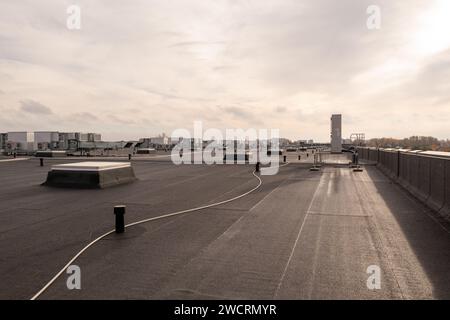 Drone photography of large commercial building rooftop with air conditioning machinery during autumn sunny morning Stock Photo