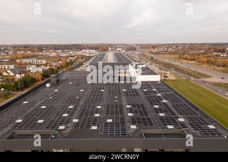 Drone photography of logistical warehouse with solar panels on the roof during autumn sunny morning Stock Photo
