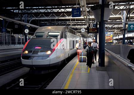 Passengers getting on a French SNCF TGV  inter city high speed train to Rennes, France at Brussels Midi international station, Belgium,  May 2023 Stock Photo