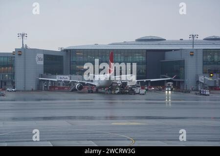ISTANBUL,TURKEY,JJANUARY 10, 2024: Airplanes at the gate of the the Istanbul new airport on a rain day. New Istanbul Airport is the main international Stock Photo