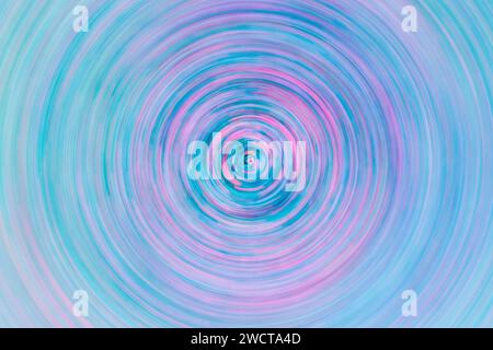 Abstract circular pattern with harmonious swirls of pink and blue hues creating a hypnotic spiral effect Stock Photo