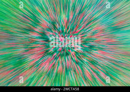 Abstract image of a field with a radial motion blur effect creating a vivid explosion of red and green streaks Stock Photo