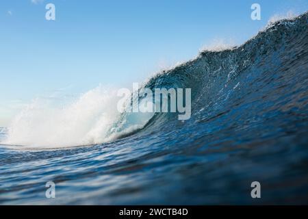 A dynamic ocean wave about to break, taken from the water's surface, showcasing the power of the sea Stock Photo