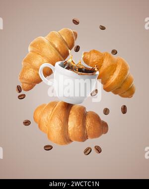 Fresh croissants, aromatic coffee and roasted beans in air on dark beige background Stock Photo