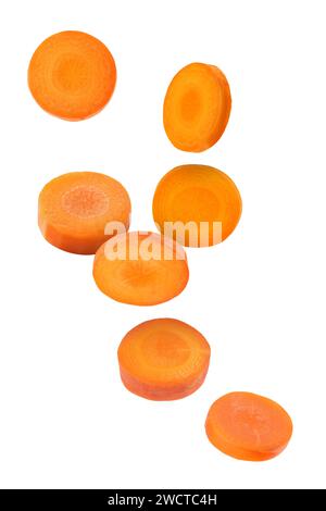 Fresh carrot slices falling on white background Stock Photo