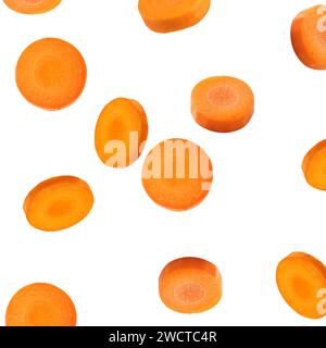 Fresh carrot slices falling on white background Stock Photo