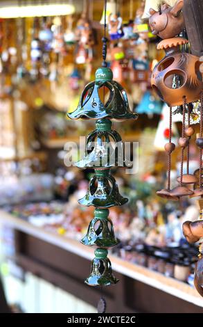 Hand made wind chimes hanging on a string with depth of field effect.  Ceramic wind chime hanging outside, selective focus, Wind bells from clay  Stock Photo - Alamy