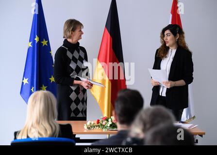 Berlin, Germany. 17th Jan, 2024. Mahdieh Hashemi (born in Iran) receives a naturalization certificate from Sonja Fietz (l) at a naturalization ceremony at the Central Naturalization Office of the State Office for Immigration (LEA) in Berlin-Wedding. The centralization of all naturalization matters is intended to make naturalization procedures more efficient and accessible. Digital processes should make it possible to complete an individual application procedure within six months. Credit: Bernd von Jutrczenka/dpa/Alamy Live News Stock Photo