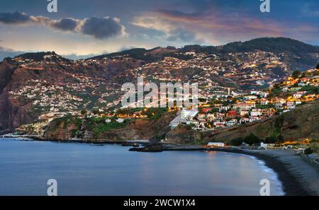 Funchal city at night  in Madeira near black Formosa beach, Portugal Stock Photo