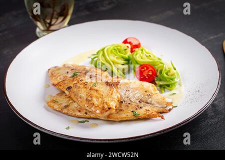 Grilled fish fillet with zucchini pasta. Healthy food concept. Stock Photo