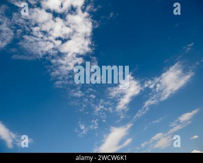 View of the blue cloudy sky directly overhead. Cloudscape Stock Photo