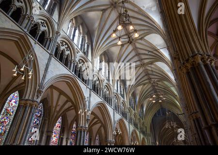 Lincoln, Lincolnshire, England. Low angle view along the nave of Lincoln Cathedral, rib vaulted ceiling prominent. Stock Photo