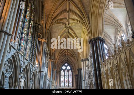 Lincoln, Lincolnshire, England. View along the north choir aisle of Lincoln Cathedral, rib vaulted ceiling prominent. Stock Photo