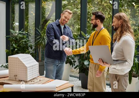 good looking happy architects in casual clothes working together on their startup, coworking concept Stock Photo