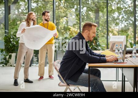 cheerful good looking businessmen in casual outfit working hard on their own startup together Stock Photo