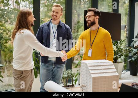 cheerful handsome architects in casual outfits working together on their startup, coworking concept Stock Photo