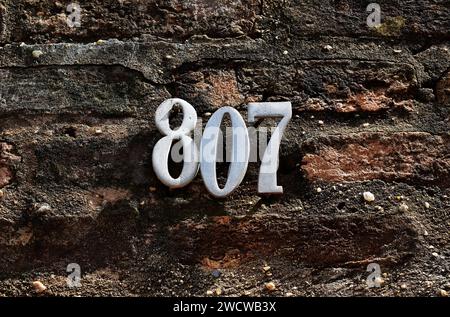 Street sign number 807 on a stone wall Stock Photo