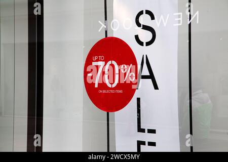 January sales 70% off red discount sign on Newlook shop front window in Exeter UK Stock Photo