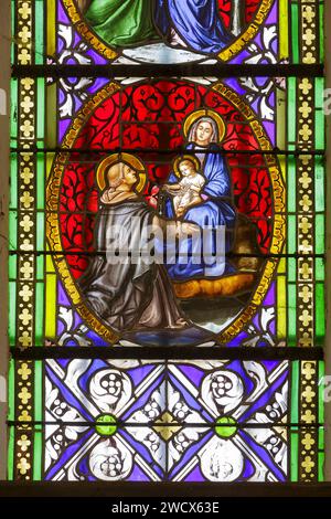 France, Meurthe et Moselle, Saintois area, Vitrey, eglise de la Nativite de la Vierge (church of the Nativity of the Virgin), detail of the stained glass window which represents scenes of the life of Virgin Mary, Virgin Mary holding the Child gives the rosary to Saint Dominique Stock Photo