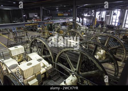 United States, California, San Francisco, in the Cable Car Museum a man monitors the condition of the cables which turn on the wheels of the lines which still operate, in the foreground motor windings Stock Photo