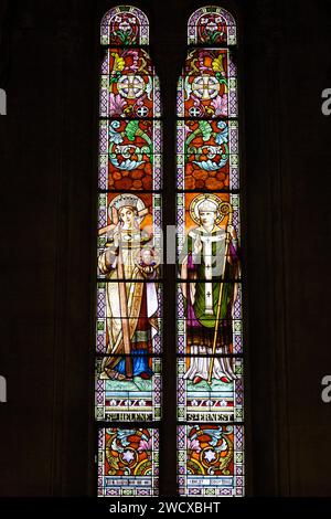 France, Meurthe et Moselle, Nancy, Saint Joseph church achieved in 1905 built in neo Romanesque style by architect Leopold Amedee Hardy, stained glass window made by master glassmaker from Nancy Georges Janin representing on the left Saint Helena empress, mother of emperor Constantin, the first christian emperor, on the right Saint Ernest (the priest who founded the church had the same first name), located Rue Mon Desert Stock Photo