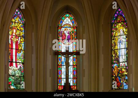 France, Meurthe et Moselle, Champenoux, Saint Barthelemy church rebuilt in 1923 after its destruction by the germans during the battle of the Grand Couronne in September 1914, stained glass windows in Art Deco style of the choir made by master glassmaker from Nancy Jacques Gruber in 1928-1929 which represent from left to right the apparition of the Sacred Heart of Jesus to Saint Marguerite Marie Alacoque in 1675 in Paray le Monial, Jesus Christ and the apparition of Virgin Mary to Bernadette Soubirous in Lourdes Stock Photo