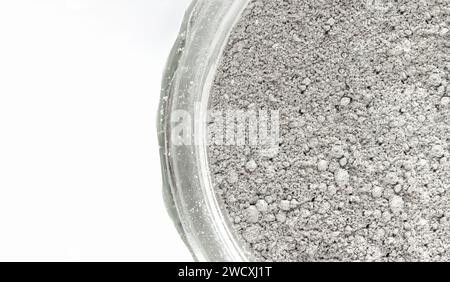Tooth powder with activated charcoal in a jar on white background. Natural product for personal care. Stock Photo