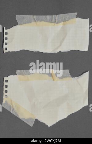 Graph torn paper with adhesive tape, scraps of paper on sticky tape, gray background. Stock Photo