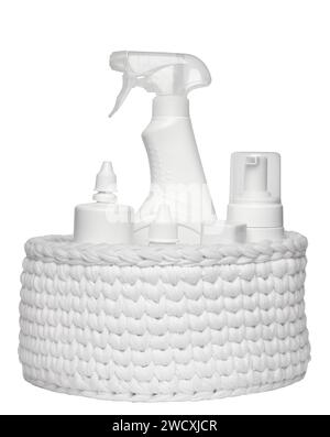 Different plastic bottles in a white knitted basket isolated on white background. Stock Photo