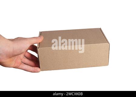 Closed cardboard box in hand isolated on white background. Stock Photo