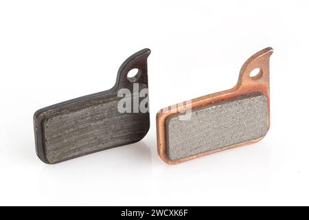 Old and new bicycle disk brake pads isolated on white background. Stock Photo