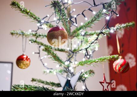 Christmas tree decorations with baubles and lights UK Stock Photo