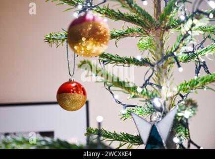 Christmas tree decorations with baubles and lights UK Stock Photo