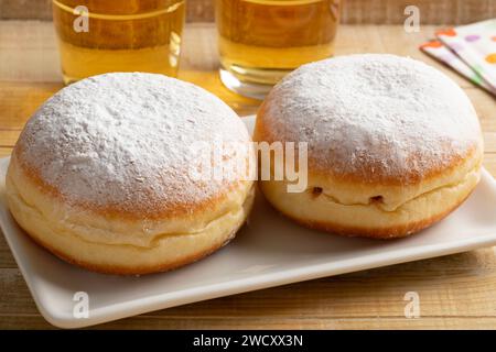 Dish with two fresh baked Berliner donuts covered with white sugar close up Stock Photo