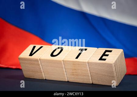 Russia vote 2024, Wooden blocks written vote 2024, Russian flag in the background. Concept of elections and voting in Russia Stock Photo