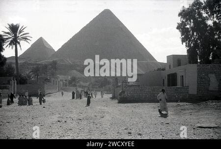 1950s, historical, Egypt, local people walking in a dusty area at Giza ...