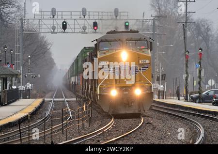 Glen Ellyn, Illinois, USA. On a foggy day, a couple of days before Christmas, multiple locomotives lead a Union Pacific freight train. Stock Photo