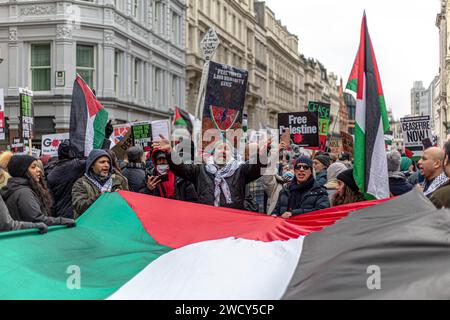 A global day of protests drew thousands of people including Children, who made their way through central London for a pro-Palestinian march, part of a global day of action against the longest and deadliest war between Israel and Palestinians in 75 years. Protesters held up banners, flags and placards as they walked along the embankment by the River Thames in support of Palestinian people in Gaza. London, United Kingdom. Stock Photo