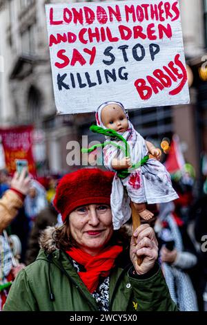 A global day of protests drew thousands of people including Children, who made their way through central London for a pro-Palestinian march, part of a global day of action against the longest and deadliest war between Israel and Palestinians in 75 years. Protesters held up banners, flags and placards as they walked along the embankment by the River Thames in support of Palestinian people in Gaza. London, United Kingdom. Stock Photo