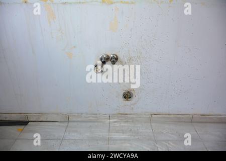 Wall with water and power connections in a kitchen during renovation during a move Stock Photo