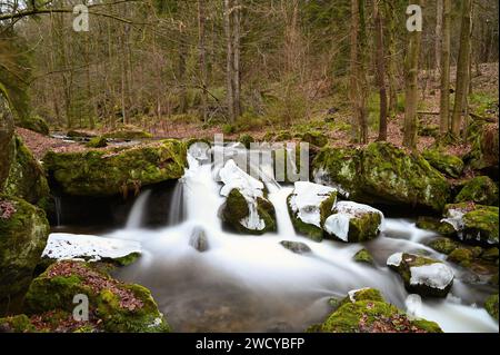 Mountain stream flowing through rocky terrain Stock Photo