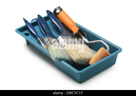 tray with used paint brushes and rollers isolated Stock Photo