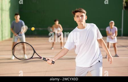 Young man playing frontenis on outdoor pelota court Stock Photo