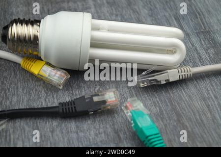 Energy-saving lamp and network plug, symbolic image for smart home Stock Photo