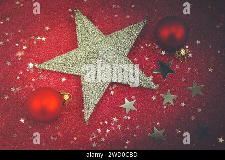 red Christmas tree baubles and silver star with silver and red stars on a red background, Christmas decoration Stock Photo
